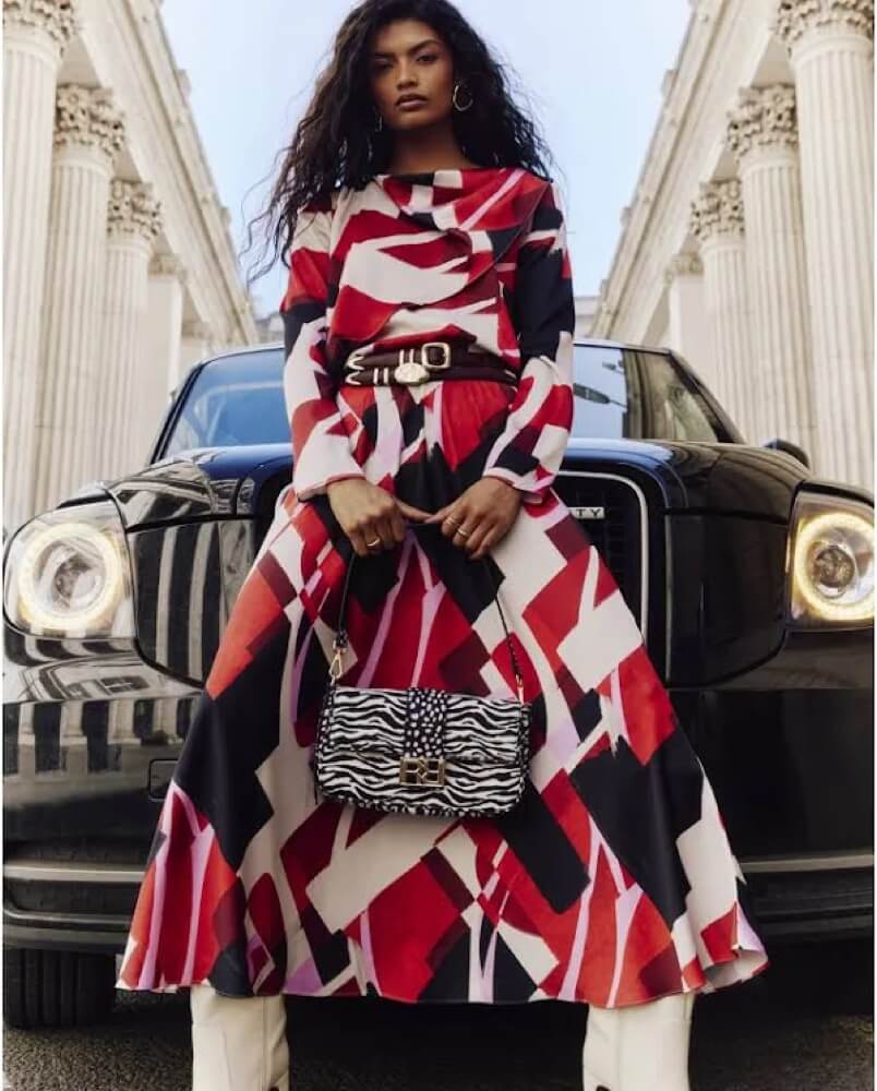 Model in a bold red and white River Island dress